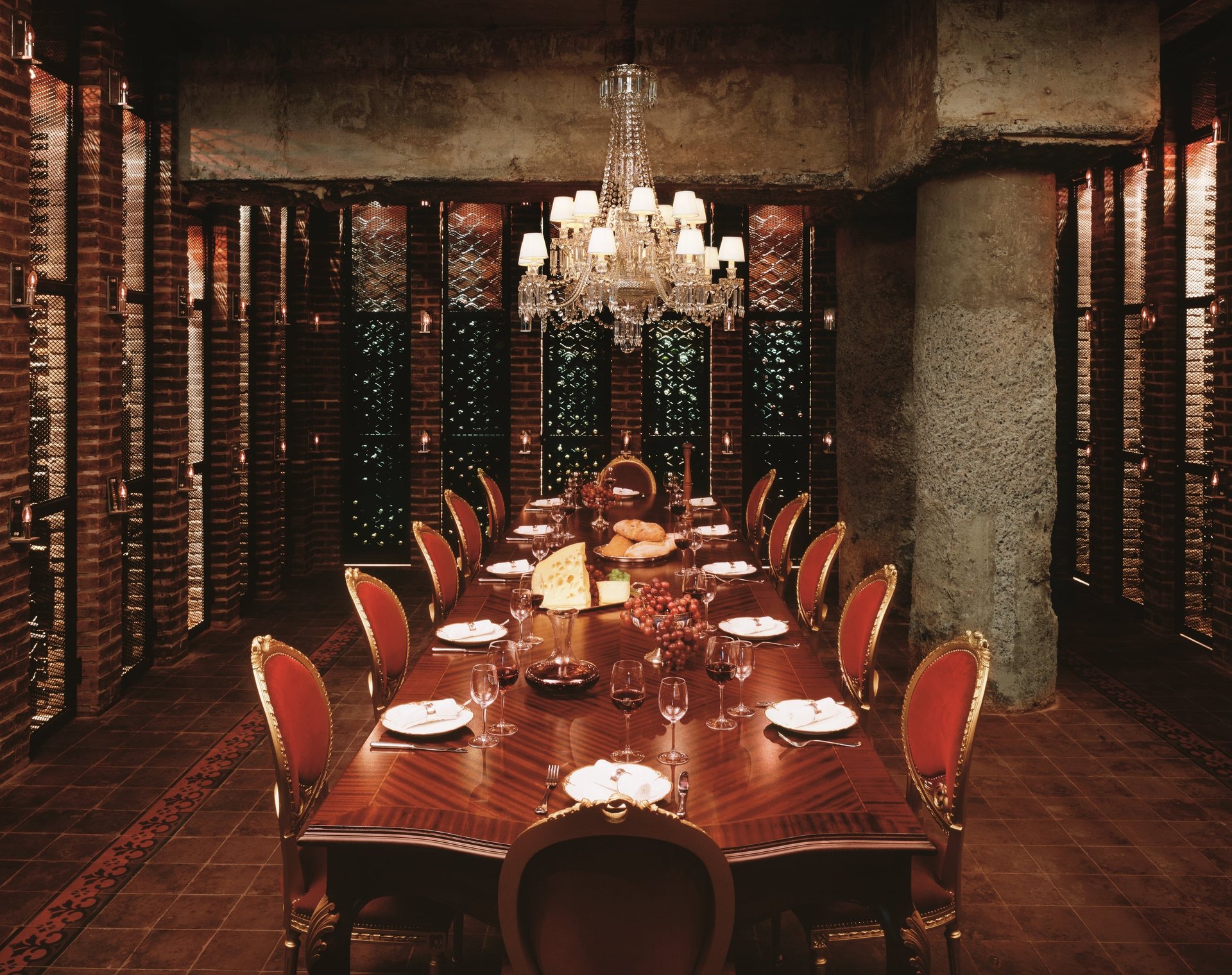 La Cava, the Faena Hotel’s brick wine cellar, with a long table laid under a crystal chandelier