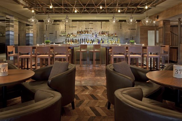 Pony Line, the bar at the Four Seasons, with leather tub chairs before the long backlit bar